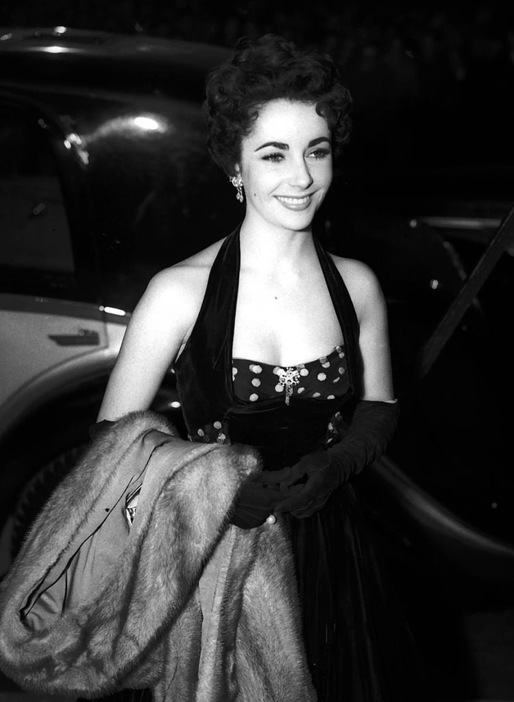 Elizabeth Taylor attends the premiere of The Lady with the Lamp in black gown
