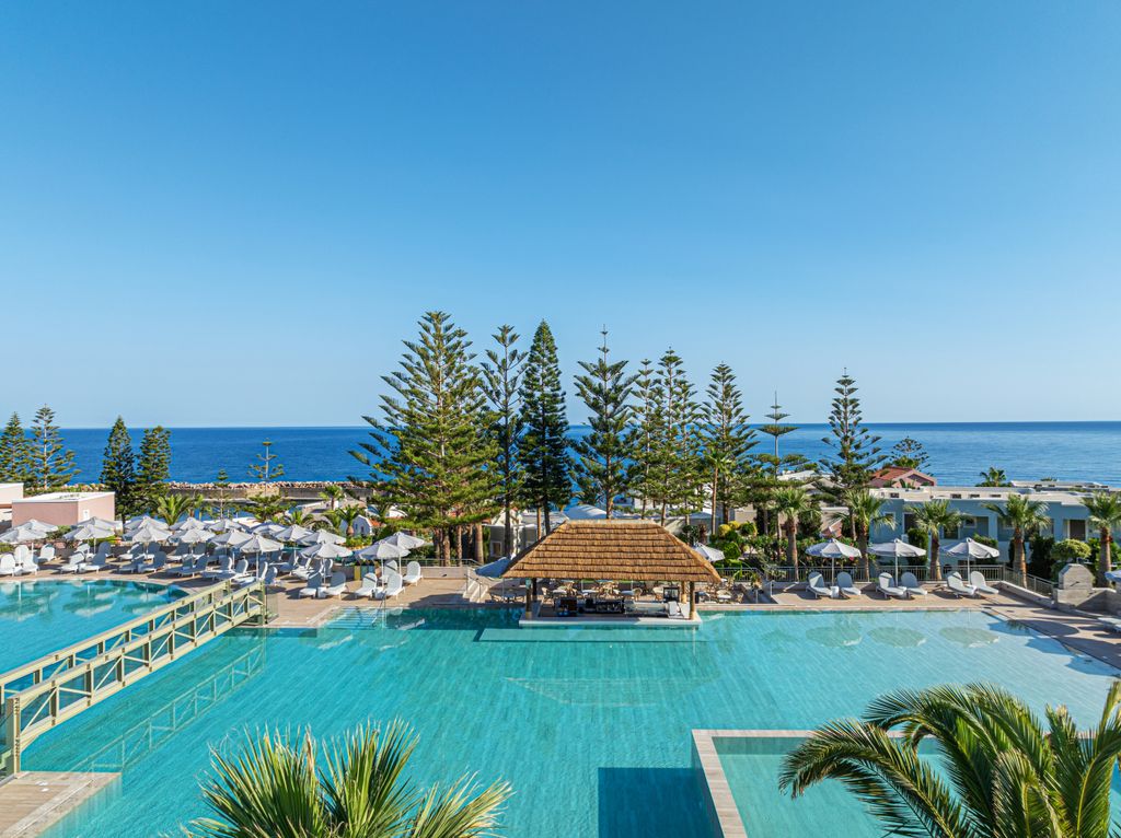 The larger of the two pools features an over-pool walkway and poolside bar