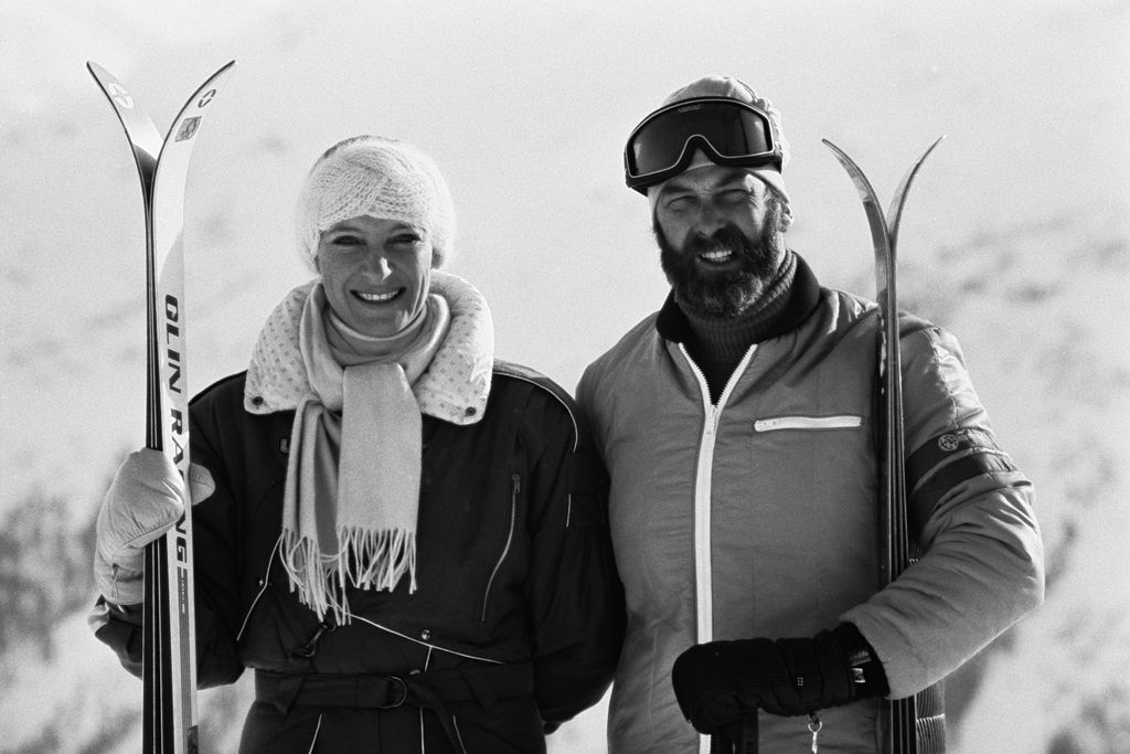 British royal Prince Michael of Kent and his wife Princess Michael of Kent, both smiling as they hold their skis on the slopes in 1985