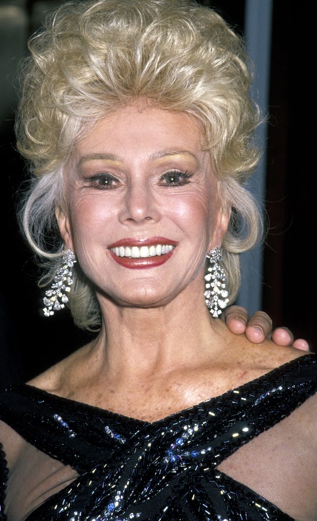 Eva smiling in a black sparkly dress