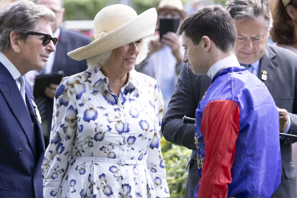 Queen Camilla speaking to a young jockey