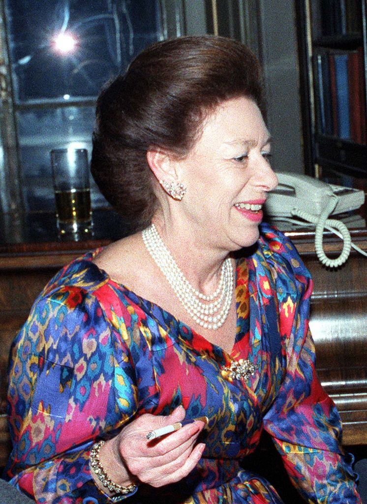 Princess Margaret holding a cigarette at the Desert Island Discs 50th birthday party at the Reform Club.