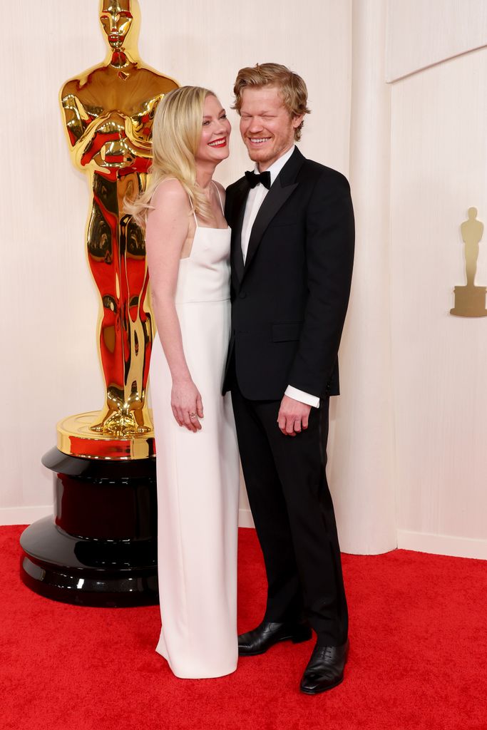 Kirsten Dunst trips on the red carpet at 2024 Oscars in headturning(00)