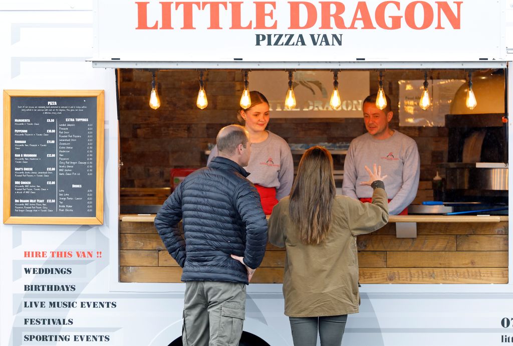 Prince William, Prince of Wales and Catherine, Princes of Wales wait for their order of takeaway pizzas, from a pizza van, Little Dragon, in Wales