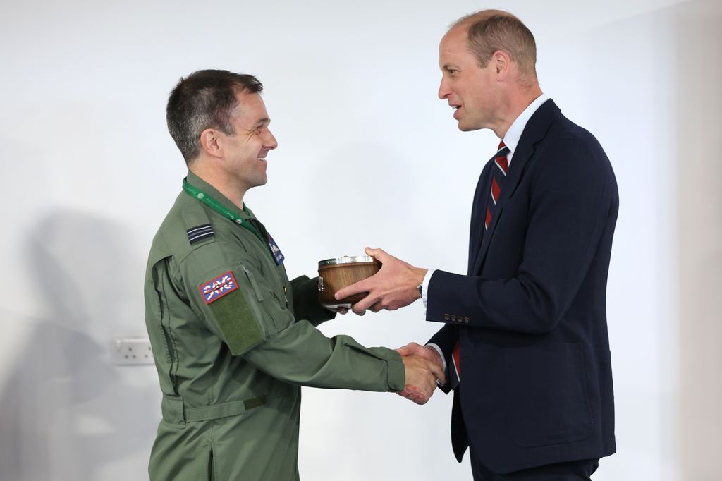 Prince William presents the The Prince of Wales Award to Flight Lieutenant Jake Fleming during an official visit at RAF Valley