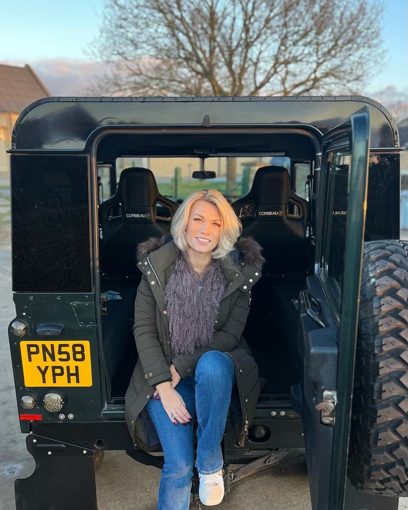 Steve Fletcher's daughter Amelia Hutchins sitting in a Land Rover