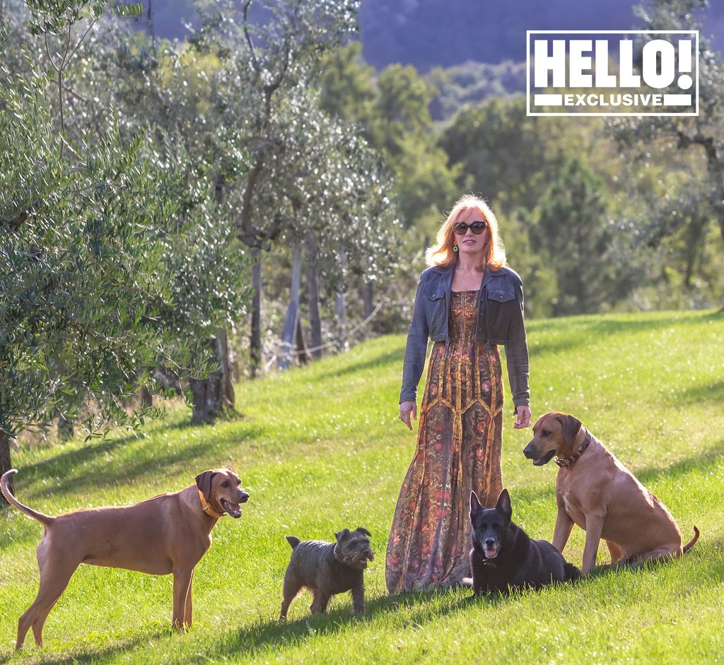 Suzanne Syz posing in Tuscany home with four pet dogs
