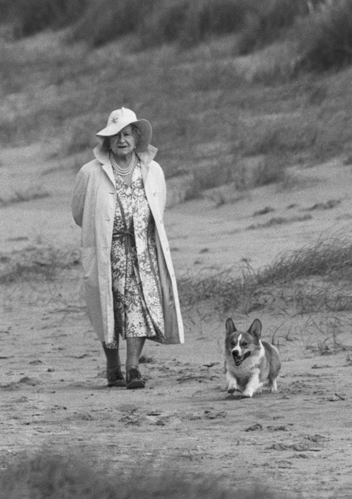 The Queen Mother walking on Holkham Beach with her beloved Corgi