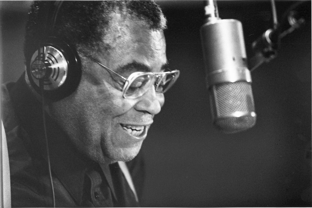 Close-up of American actor James Earl Jones, headphones on his head, as he speaks in a microphone in a recording studio, Hollywood, California, July 10, 1991