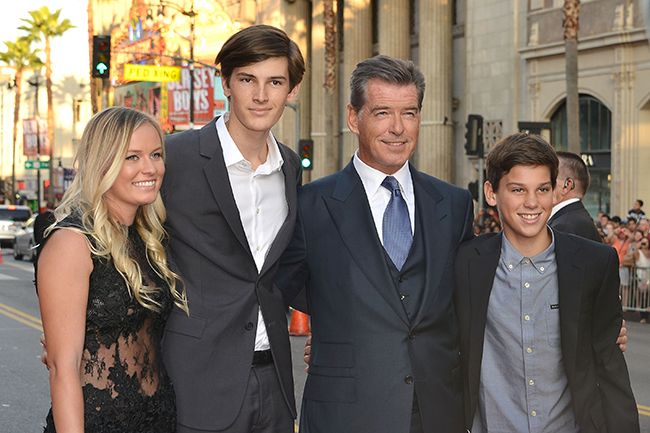 Dylan Brosnan with short hair standing with Pierce and Paris