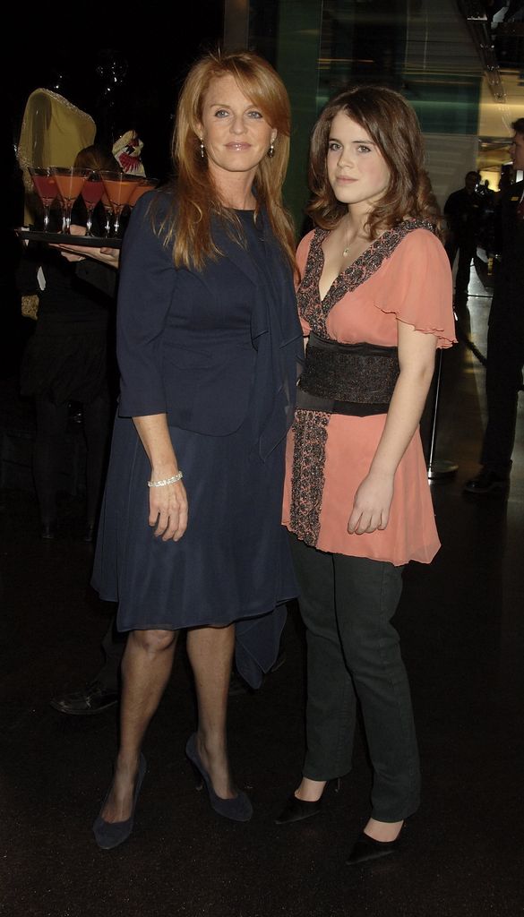 fergie and eugenie - wearing black jeans and a floaty coral top