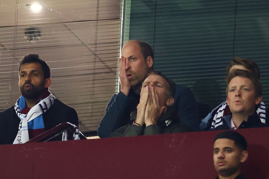 Prince William puts hand over face at football match