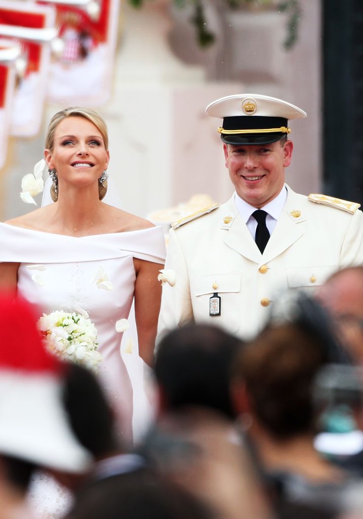 MONACO - JULY 02:  Princess Charlene of Monaco and Prince Albert II of Monaco leave the religious ceremony of the Royal Wedding of Prince Albert II of Monaco to Princess Charlene of Monaco at the Prince's Palace on July 2, 2011 in Monaco. The Roman-Catholic ceremony follows the civil wedding which was held in the Throne Room of the Prince's Palace of Monaco on July 1. With her marriage to the head of state of Principality of Monaco, Charlene Wittstock has become Princess consort of Monaco and gain the title, Princess Charlene of Monaco. Celebrations including concerts and firework displays are being held across several days, attended by a guest list of global celebrities and heads of state.  (Photo by Dan Kitwood/Getty Images)