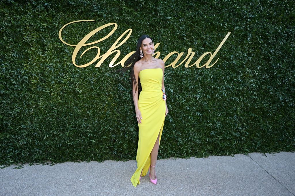 Demi Moore against leafy backdrop in yellow