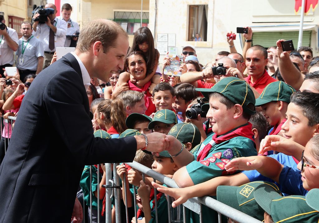 Prince William greeting the crowds in Malta in 2014