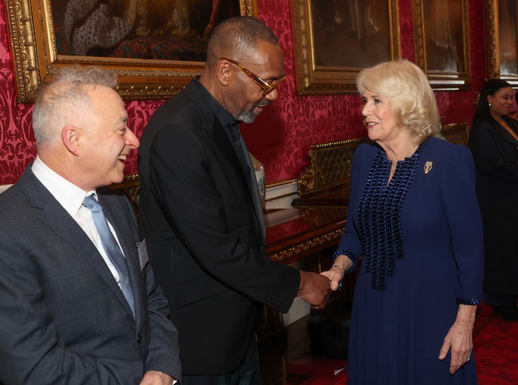 Queen Camilla shaking hands with Sir Lenny Henry