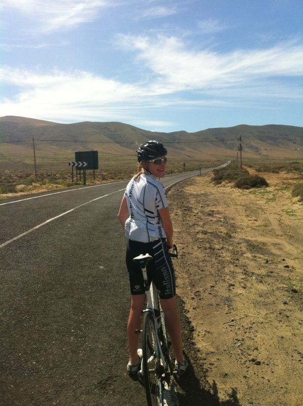 Woman on a bike on a sunny path 