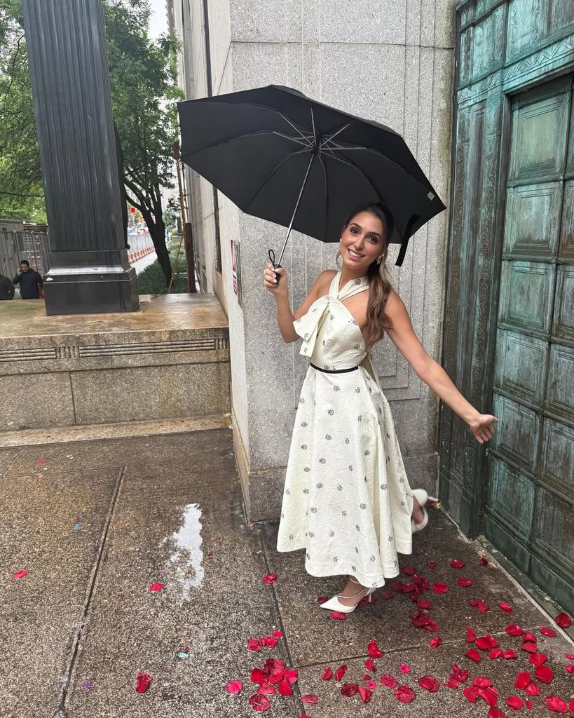 Princess Iman of Iran under an umbrella standing on rose petals
