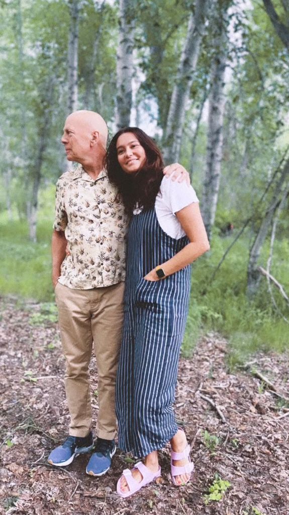 Bruce Willis cradles his wife Emma as they enjoy an outdoor walk