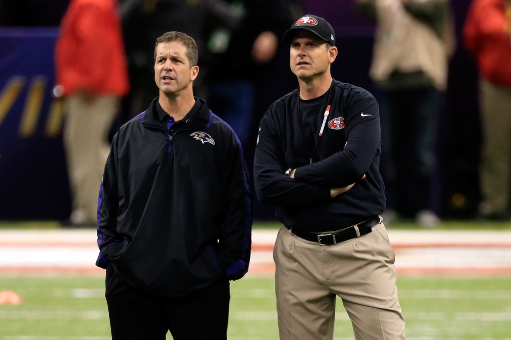 NEW ORLEANS, LA - FEBRUARY 03: Head coach John Harbaugh of the Baltimore Ravens (L) and head coach Jim Harbaugh of the San Francisco 49ers speak during warm ups prior to Super Bowl XLVII at the Mercedes-Benz Superdome on February 3, 2013 in New Orleans, Louisiana.  (Photo by Jamie Squire/Getty Images)