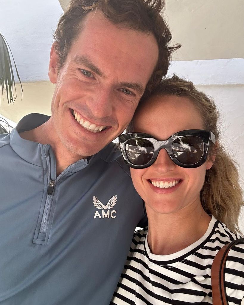 Andy Murray smiling as he hugs his wife Kim on holiday