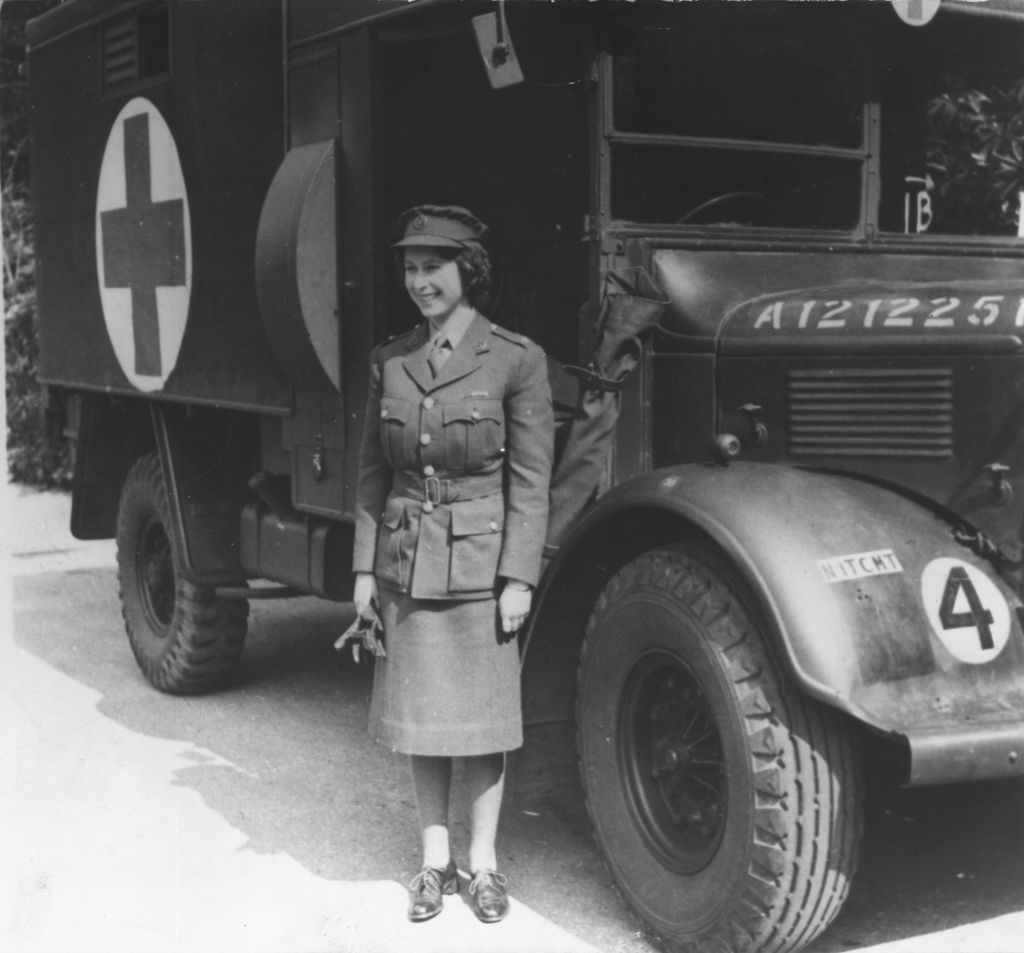 The Queen in military uniform in front of a first aid truck