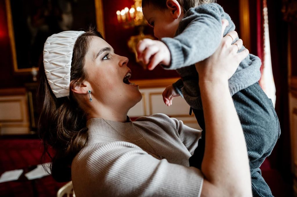 Princess Eugenie holding baby Ernest in the air