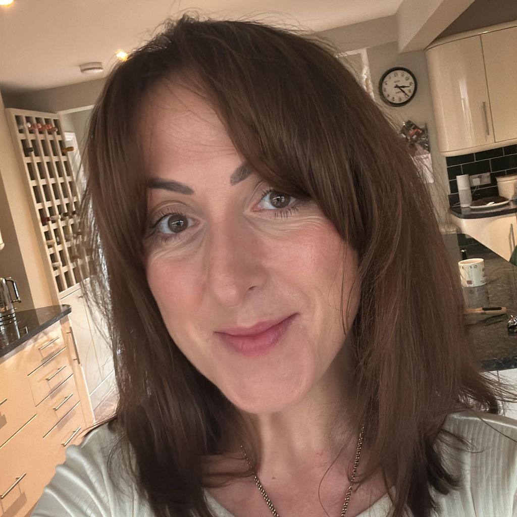 Natalie Cassidy taking a selfie in front of her wine rack