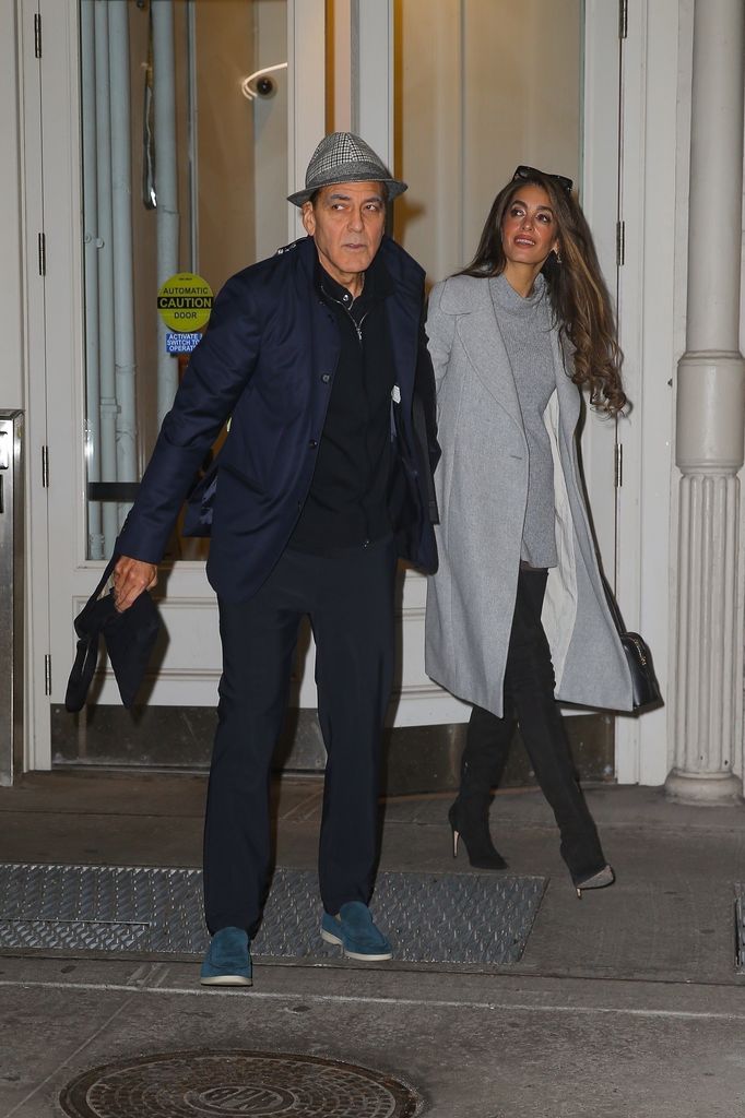 George Clooney and his wife Amal Clooney hold hands as they head out together in New York.