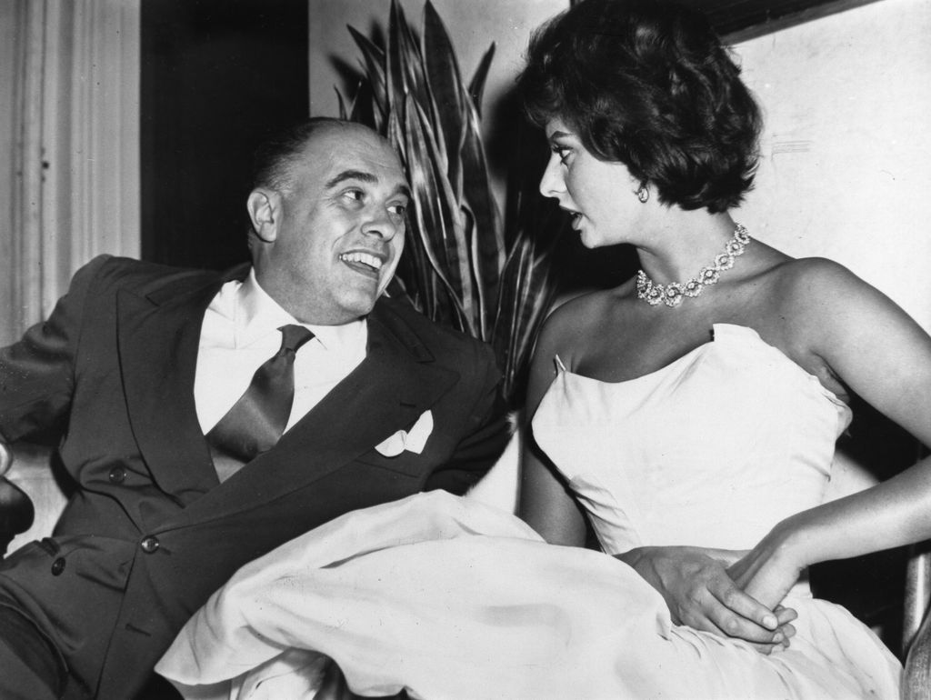 Sophia Loren sits with Carlo Ponti in 1957