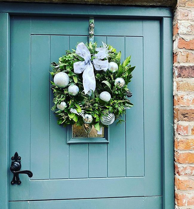 teal door with wreath