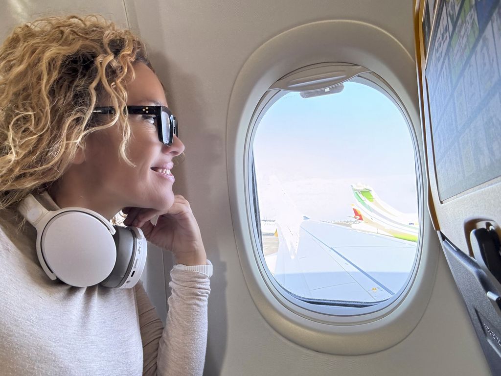 woman looking out of airplane window