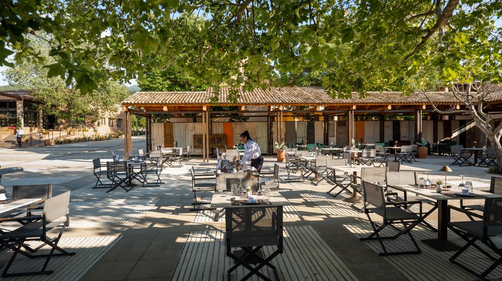 outdoor hotel restaurant surrounded by trees