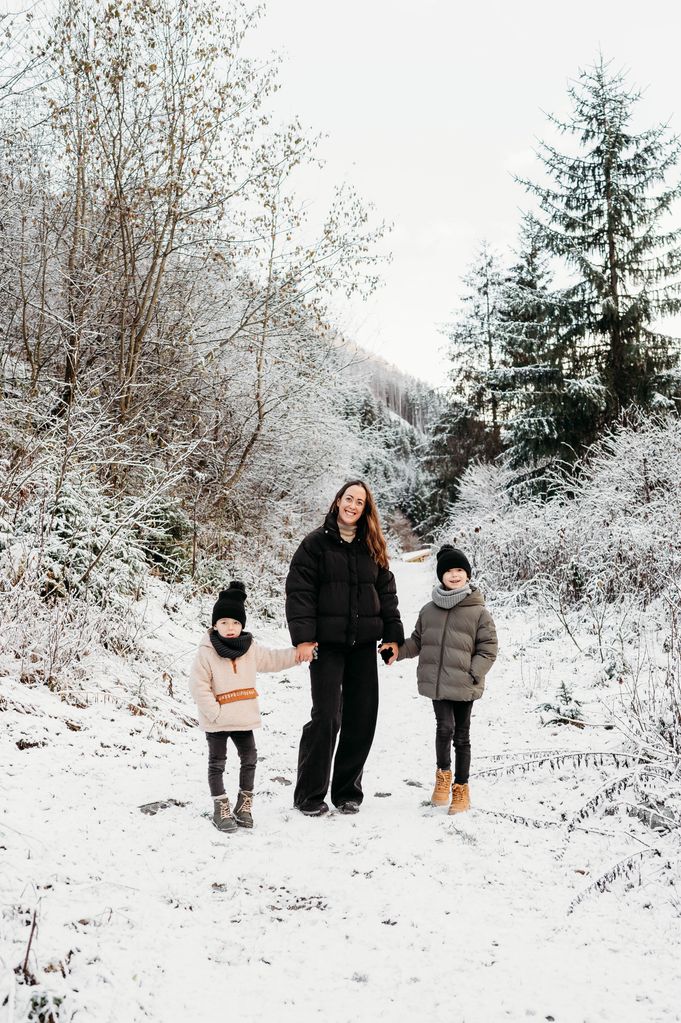 A woman with her two sons in the snow