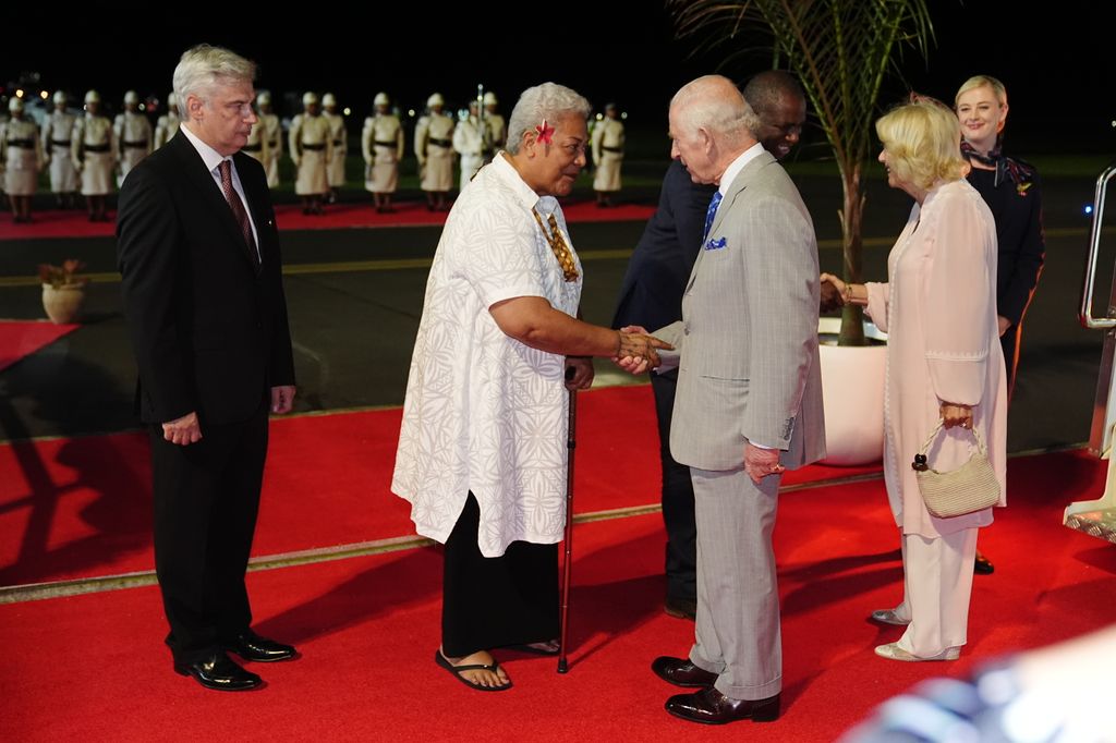 King Charles is greeted by Samoa's Prime Minister Fiame Naomi Mata'afa and Queen Camilla is greeted by Foreign Secretary David Lammy