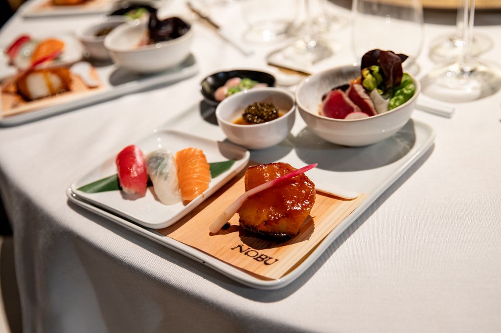 Five Nobu dishes sit on a square plate