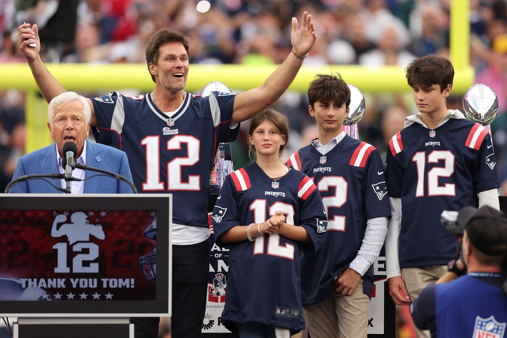 FOXBOROUGH, MASSACHUSETTS - SEPTEMBER 10: New England Patriots owner Robert Kraft speaks while former New England Patriots quarterback Tom Brady reacts while Brady's children, Vivian, Benjamin, and Jack, look on during a ceremony honoring Brady at halftime of New England's game against the Philadelphia Eagles at Gillette Stadium on September 10, 2023 in Foxborough, Massachusetts. (Photo by Maddie Meyer/Getty Images)