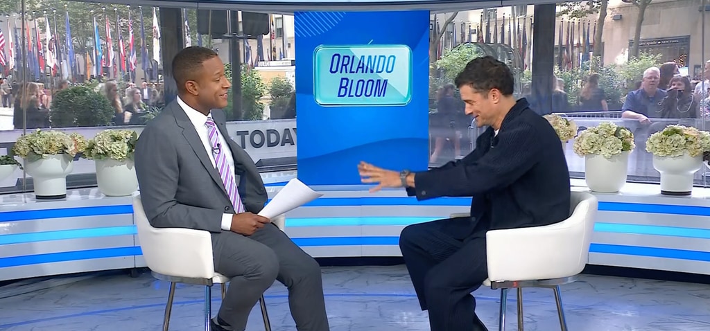 Orlando Bloom in navy blazer and Craig Melvin in gray suit sitting in Today studios
