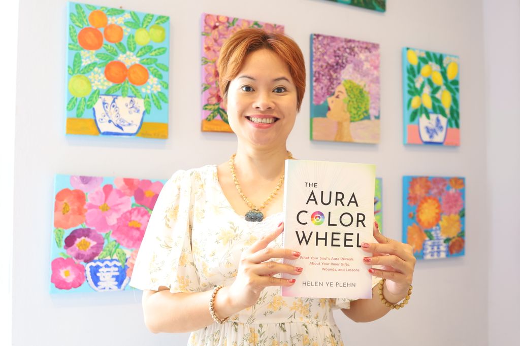 Helen holding her new book The Aura Colour Wheel