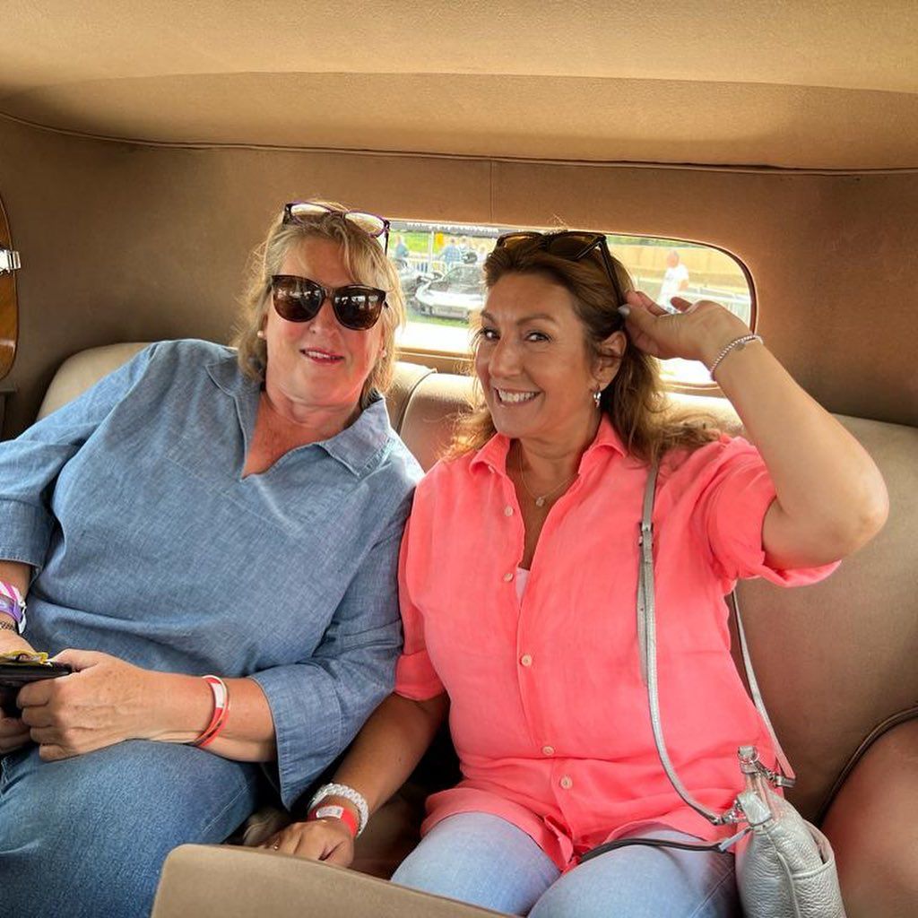 Jane McDonald and her friend sitting in the back of a car 
