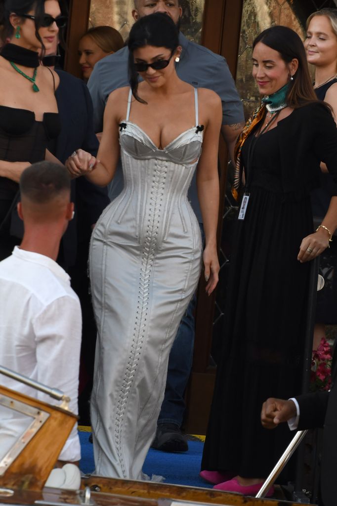 Kylie Jenner wore a silver corseted dress with bow details and a figure-hugging silhouette for the Bezos wedding celebrations