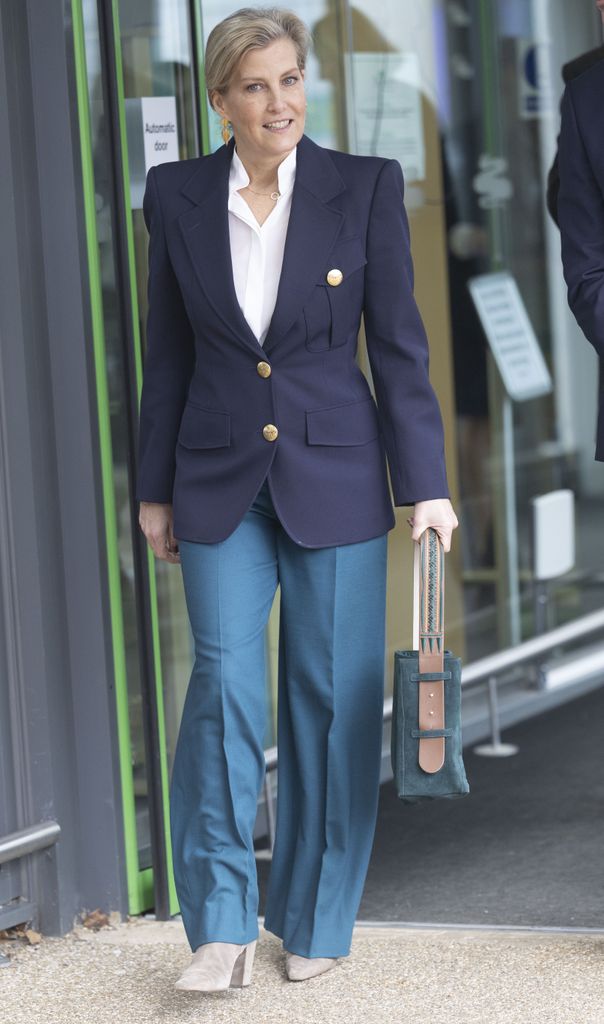 Sophie in teal trousers and navy blazer