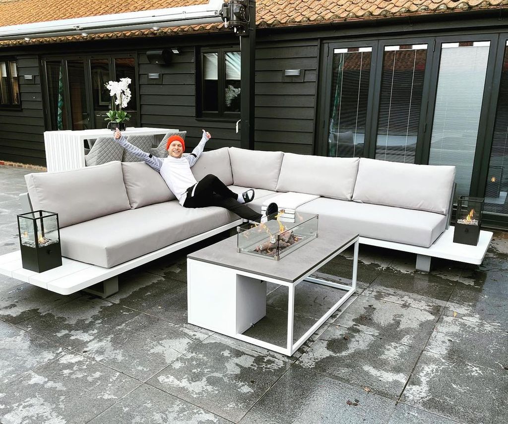 Olly Murs sitting on an outdoor sofa in the winter