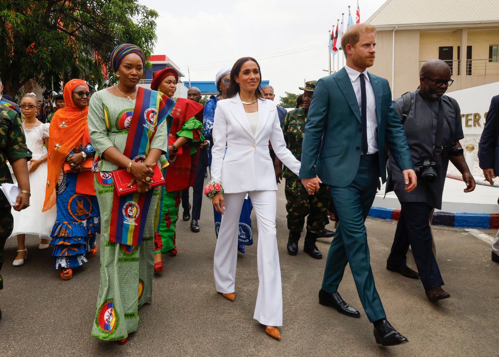 Meghan Markle and Prince Harry wholding hands in Nigeria