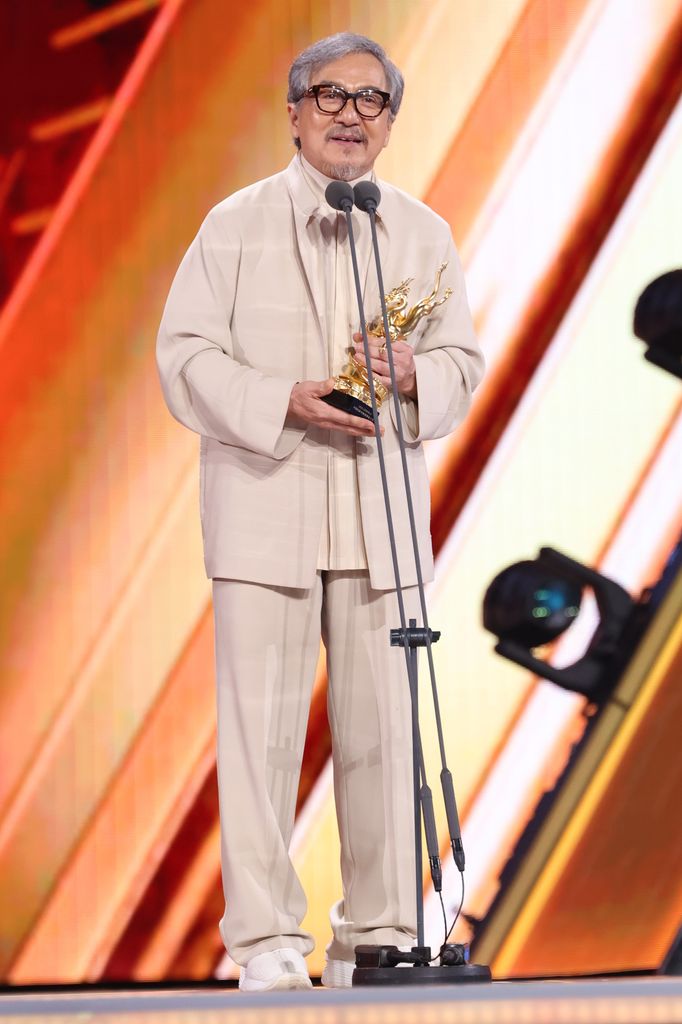 Actor Jackie Chan poses with trophy on the stage during the China Movie Data Gala and Awards Ceremony of China Movie Channel M-Chart on April 12, 2024 in Jingzhou, Hubei Province of China.