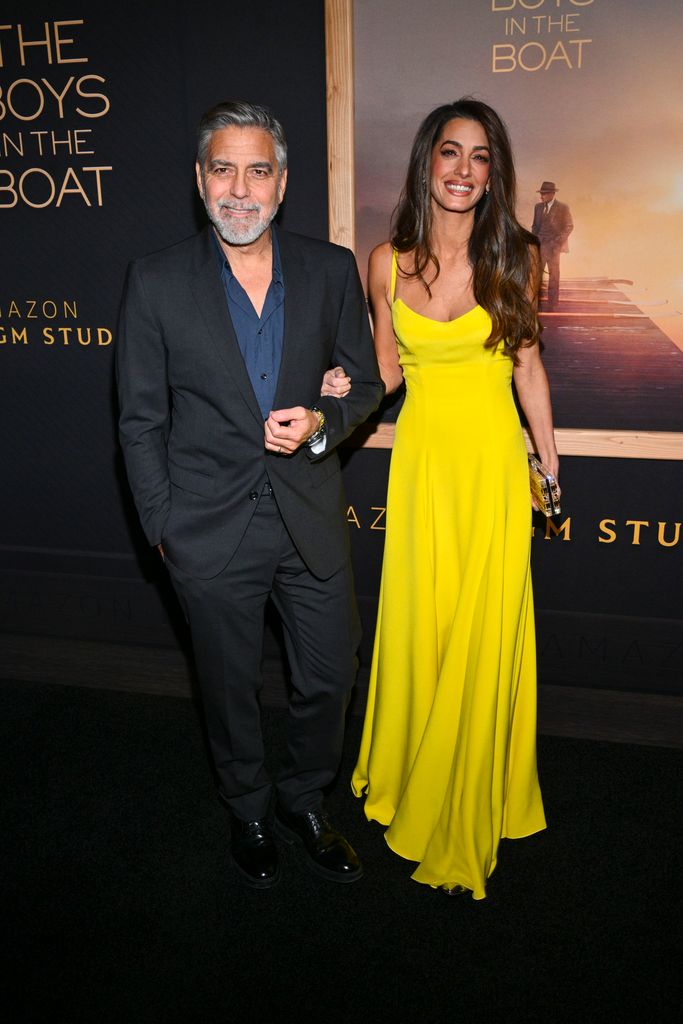 Amal in yellow dress with george in suit 