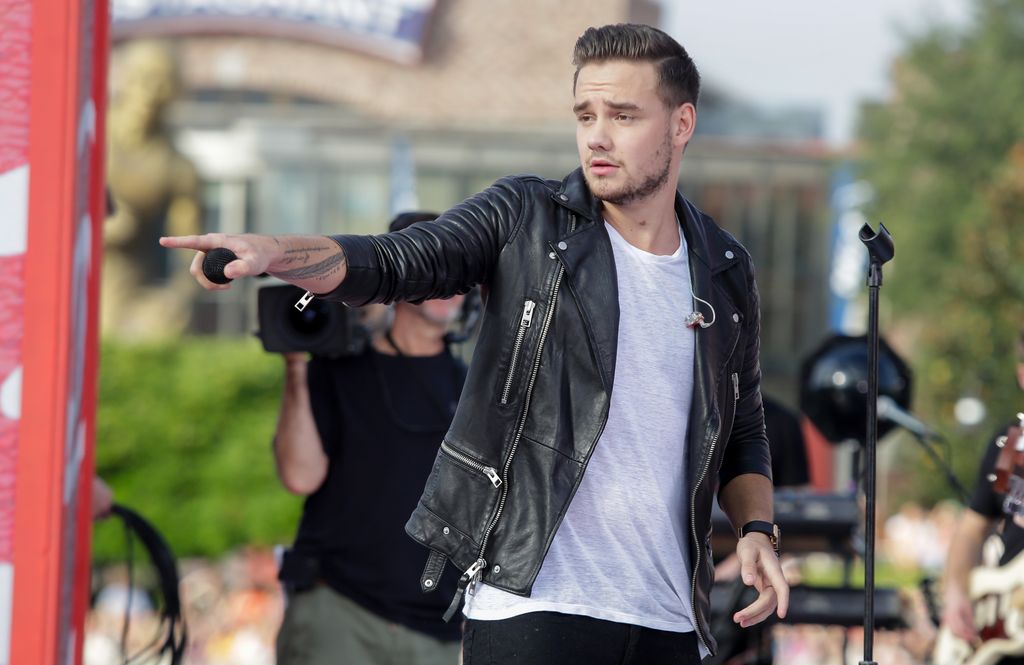 Liam Payne on stage in a leather jacket 