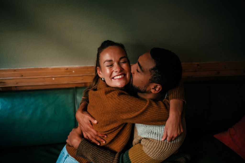Young couple hugging in a cafe