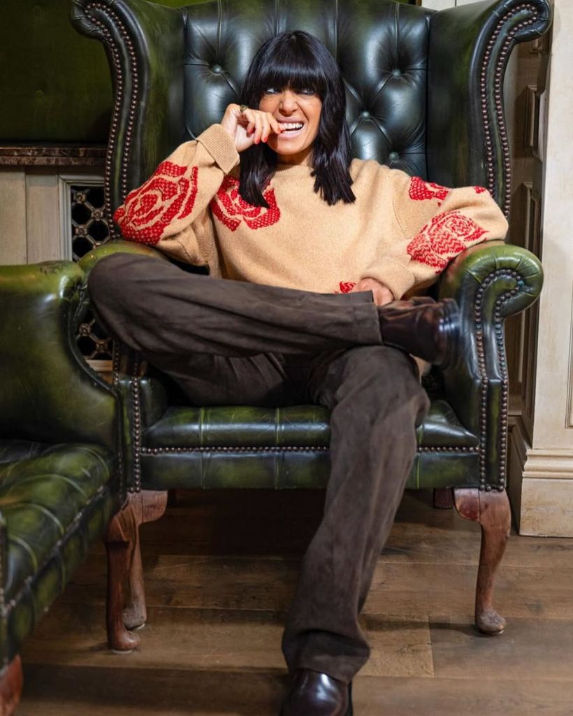 Claudia Winkleman rose print jumper on the traitors with trousers and boots