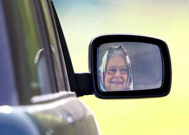 queen smiling driving car mirror